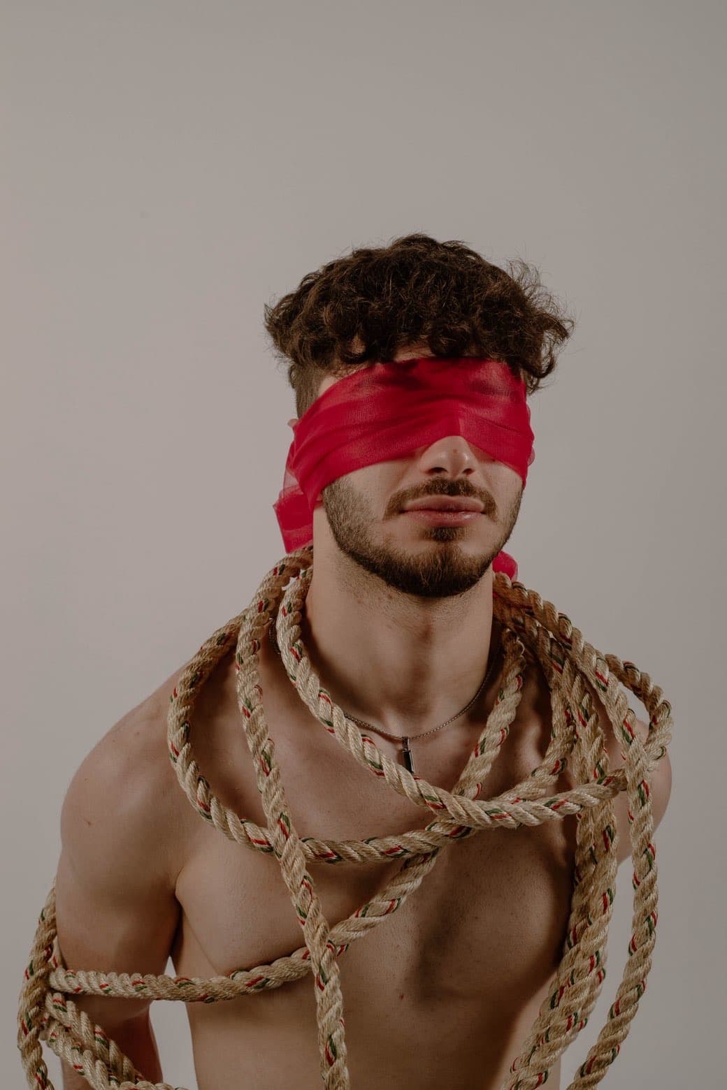 Close portrait with red blindfold and rope styling