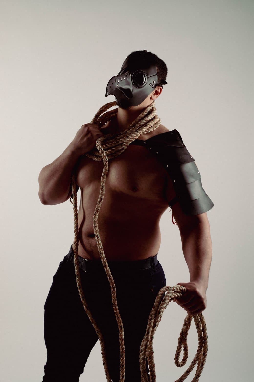 Dramatic studio portrait with rope and face paint