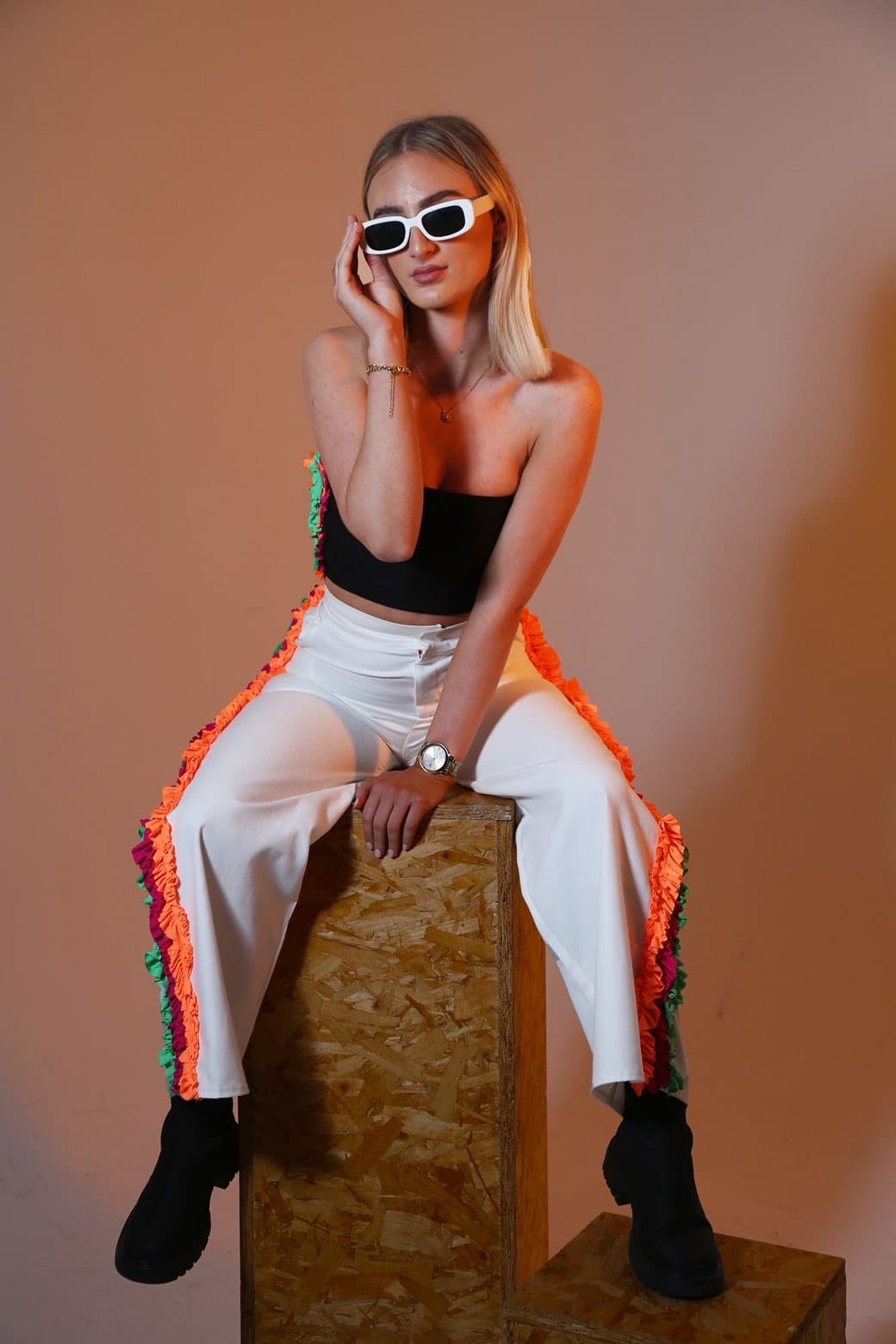 Seated fashion portrait with white sunglasses